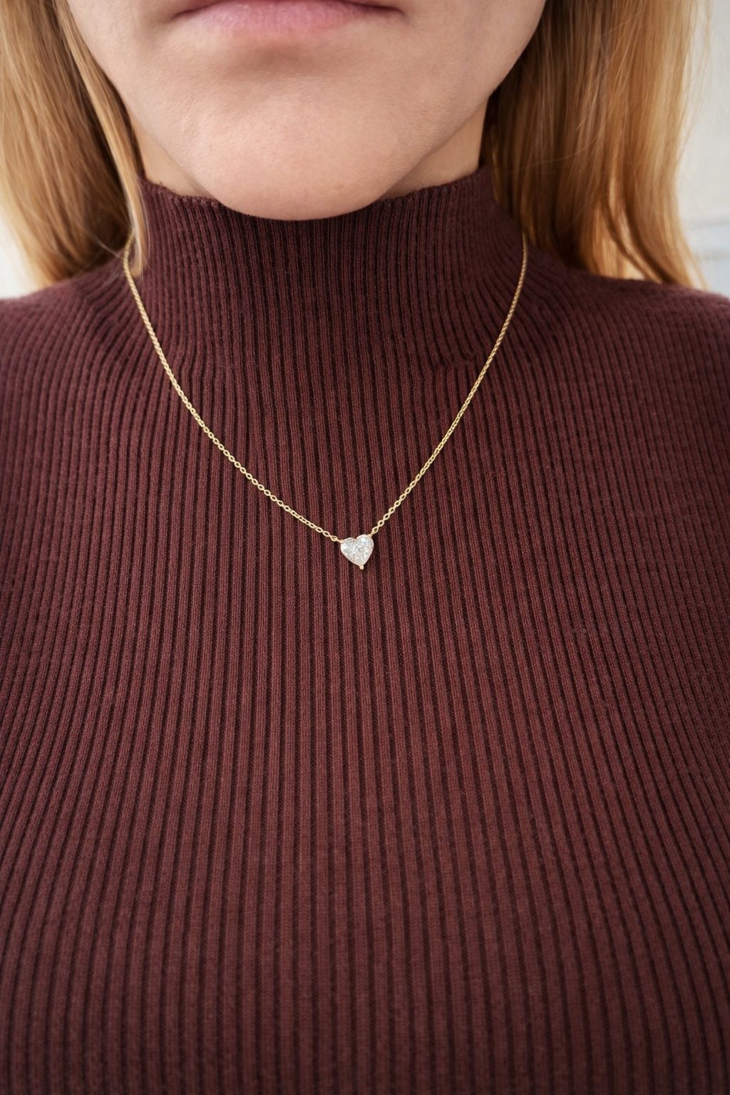 close-up image of ALVA You have my Heart Necklace in yellow gold in a model's neck.