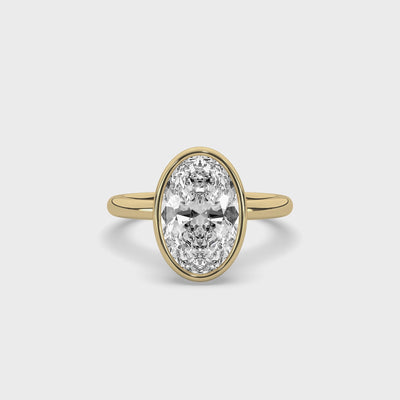 product video of ALVA Bezel Oval Diamond Solitaire Ring in yellow gold in a white background